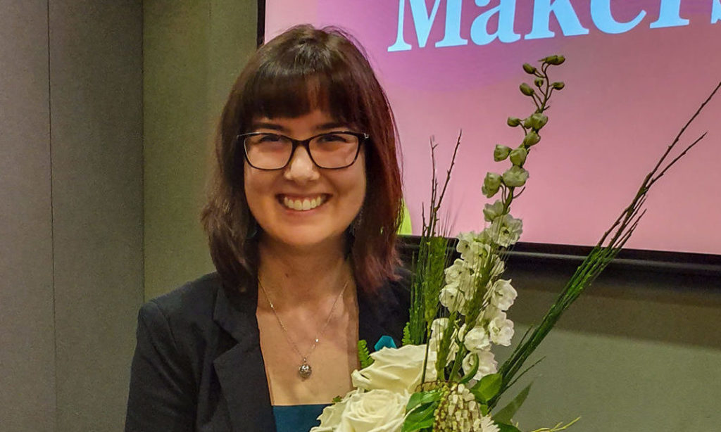 A former Luther College student receives an award at the Change Makers Conference