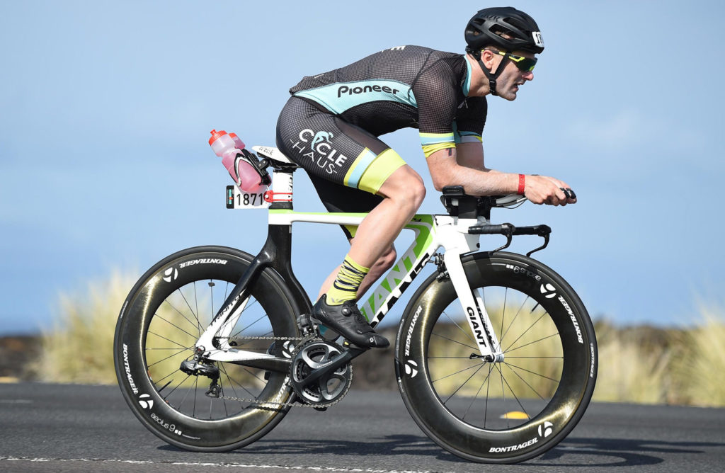Alum Ryan Walkenhorst riding a bicycle as part of World Ironman Championship